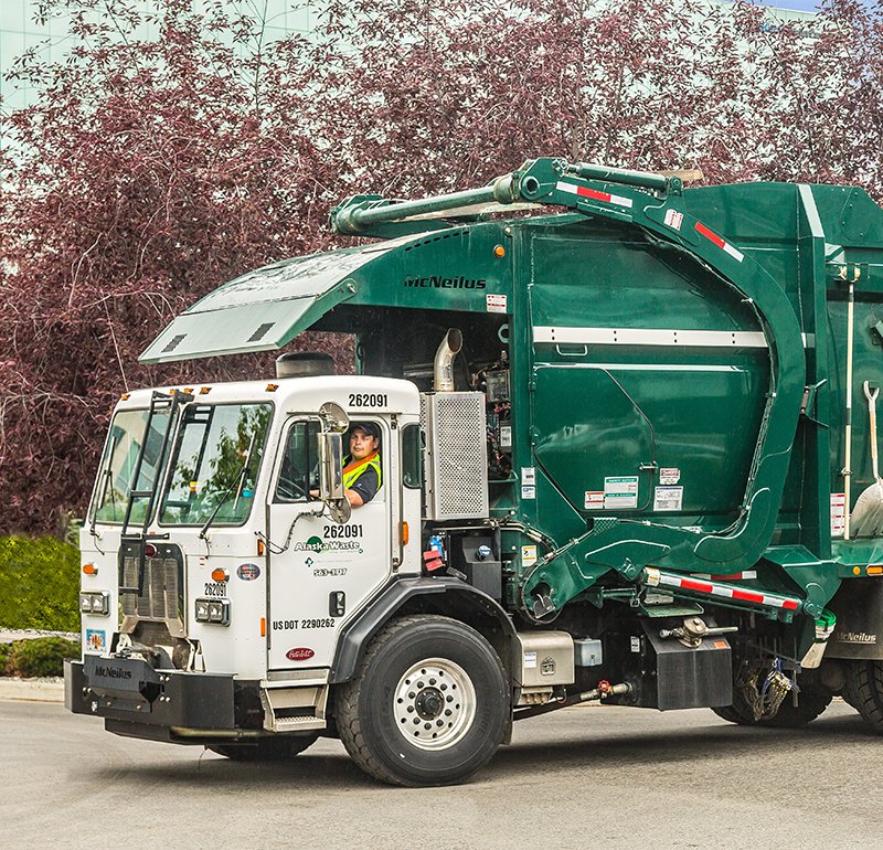 Photo of Alaska Waste Commercial Service truck and driver.