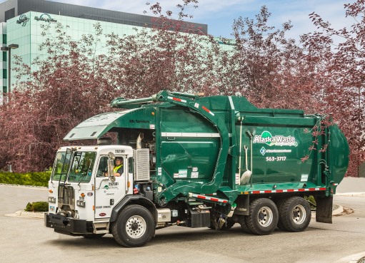 Picture of an Alaska Waste Commercial Services truck on the road.